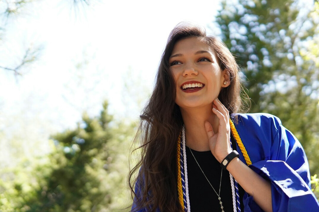 Portrait of a smiling South Asian woman in a dark blazer